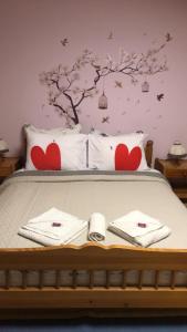 a bed with two towels and hearts on it at Babaház in Bodajk