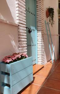 a blue door and a flower box with flowers in it at El Nogal Home in Málaga