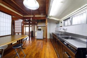 a large kitchen with a sink and a counter at Kume Azuma Villa in Kumejima