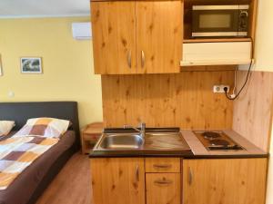 A kitchen or kitchenette at Ilona Apartmanház