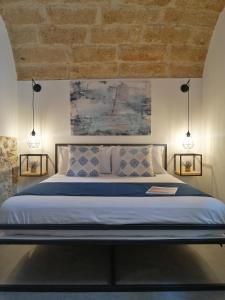 a bedroom with a bed with two lights above it at B&B Sea Salt in Terrasini
