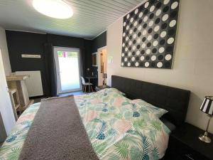 a bedroom with a bed with a comforter on it at Repos De La Fontaine in Spa