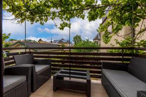 a balcony with chairs and a table on a balcony at Palangos Vila in Palanga