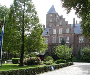 a large building with a flag in front of it at Kasteel de Wittenburg in Wassenaar