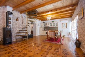 a large living room with a table and a stove at EASY HOLIDAY in Skradin