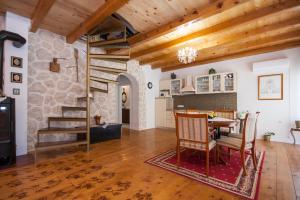 a kitchen and dining room with a table and chairs at EASY HOLIDAY in Skradin