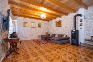 a living room with a couch and a stove at EASY HOLIDAY in Skradin