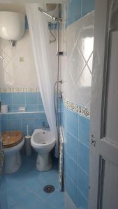 a blue bathroom with a toilet and a sink at La Casa Sugli Archi in Ponza +53 photos