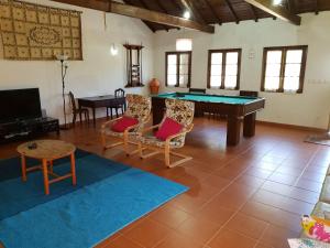 a living room with a pool table and chairs at Casa Do Fiscal in Barroselas