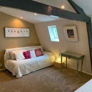 a bedroom with a bed and a table at Holiday home at the water, fire place, boat and SUP rent, near Amsterdam in Aalsmeer