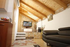 a living room with a couch and a tv at Villa Urbi et Orbi in Split