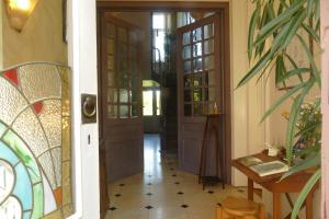 a hallway of a home with doors and a tile floor at B&B Villa Emma in Ghent