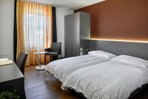 Postelja oz. postelje v sobi nastanitve Hotel du Commerce