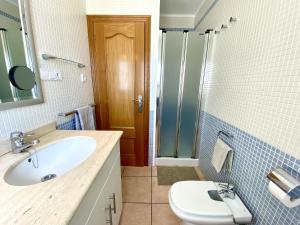 a bathroom with a sink and a shower and a toilet at House in front of the beach with sea view in Cambrils +26 photos