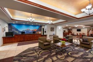 a lobby with a waiting room with a large screen at La Quinta by Wyndham Rifle in Rifle