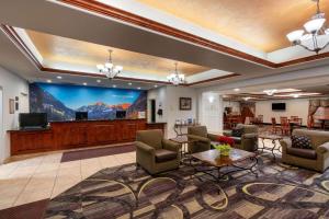 a lobby with a waiting room with a large screen at La Quinta by Wyndham Rifle in Rifle
