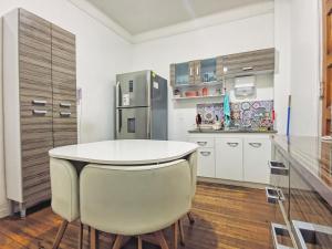 a kitchen with a white table and two chairs at Hostal Boutique Casa La Barca in Santiago
