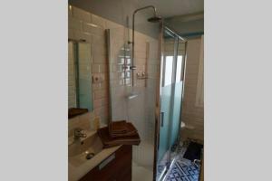 a bathroom with a shower and a sink and a mirror at El Apartamento de Marta in A Coruña