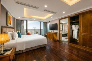 a hotel room with a bed and a television at Hanoi Dalvostro Valentino Hotel & Spa in Hanoi