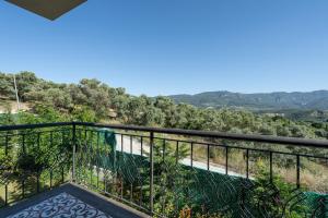 a balcony with a view of the mountains at Vintage Villas in Kusadası