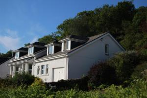 a white house with a white garage at Clyde View B&B in Dunoon