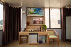 an office with a desk and two chairs and a window at Candy Hotel in Ha Long