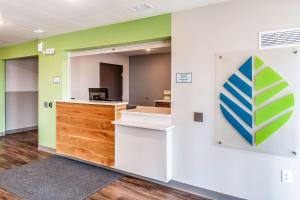 an office with a desk and a sign on a wall at WoodSpring Suites Indianapolis Zionsville in Whitestown