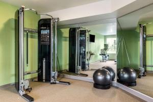 a mirror in a gym with a man in the reflection at WoodSpring Suites Indianapolis Castleton in Indianapolis