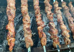 a group of bacon cooking on a grill at Rauhan Marinella Village in Imatra