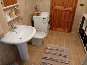 a bathroom with a sink and a toilet at Casa Vacanza Giardino in Guardiabruna +36 photos