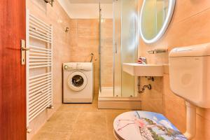 a bathroom with a washing machine and a sink at Apartments Marija Pula in Pula