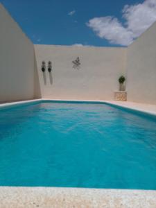 a swimming pool with blue water in a room at Casa Luna in Santiago de la Ribera