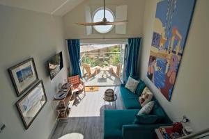 an overhead view of a living room with a blue couch at Beach Hut Suites in Bognor Regis
