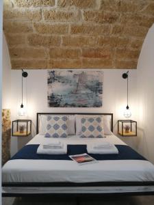 a bedroom with a large bed with two pillows at B&B Sea Salt in Terrasini
