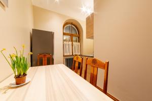 a dining room with a wooden table and chairs at Cozy Storie's AP, 47sqm, Renovated 2020, Free parking in Riga