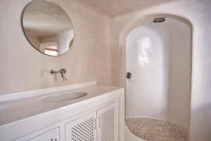 a white bathroom with a sink and a mirror at Villa Santa Katerina - Sea View & Outdoor Hot Tub in Platis Yialos Mykonos +94 photos