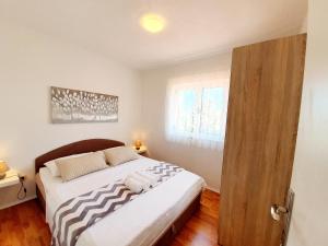 Posteľ alebo postele v izbe v ubytovaní Apartmani Mikulić