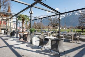 a large outdoor area with benches and tables at Hapimag Ferienwohnungen Interlaken in Interlaken