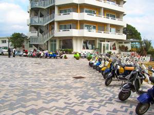 a row of scooters parked in front of a building at Torre Del Sole in Terracina