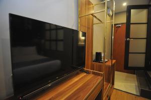 a living room with a large flat screen tv at Skye Hotel Sunway in Petaling Jaya