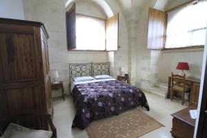 Кровать или кровати в номере Masseria Gattamora