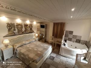 a hotel room with a large bed and a large window at B&B Triskèles in Giardini Naxos