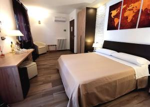 a hotel room with a large bed and a desk at Sunset Bed & Breakfast in Peschici