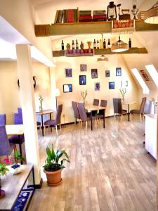a restaurant with tables and chairs in a room at Old Town Mtatsminda in Tbilisi City