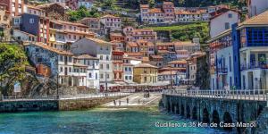 a view of a city with a bridge and water at Casa Manoli Luarca in Almuña +40 photos