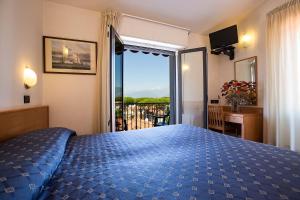 Postel nebo postele na pokoji v ubytování Hotel Fortunella