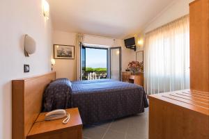 Postel nebo postele na pokoji v ubytování Hotel Fortunella + 37 fotografií
