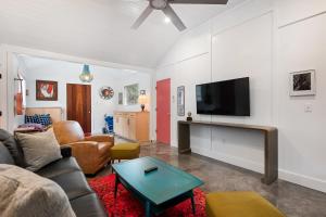 a living room with a couch and a flat screen tv at Folly Vacation 209 East, Modern, Sassy and 3 Blocks to the Beach in Folly Beach