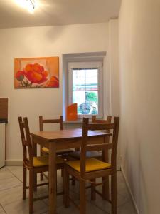 a dining room with a wooden table and chairs at Vila Anton in Karlovy Vary