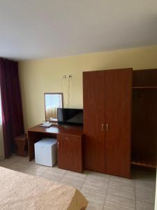a bedroom with a desk with a computer on it at Hotel Terra in Eforie Nord